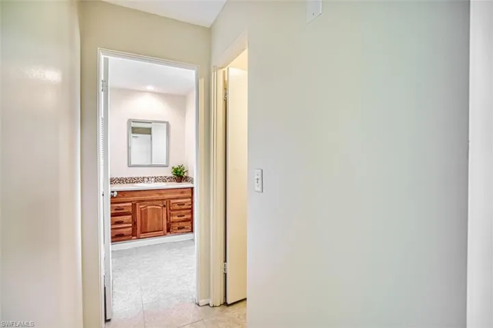 Corridor with light tile patterned floors