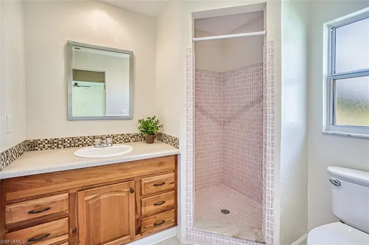 Full bathroom with vanity and a stall shower
