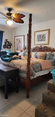 Bedroom featuring ceiling fan and tile patterned flooring