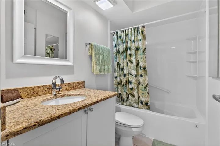 The guest bathroom has newer cabinet and granite countertops. The entire tub and surround were replaced in 2024.