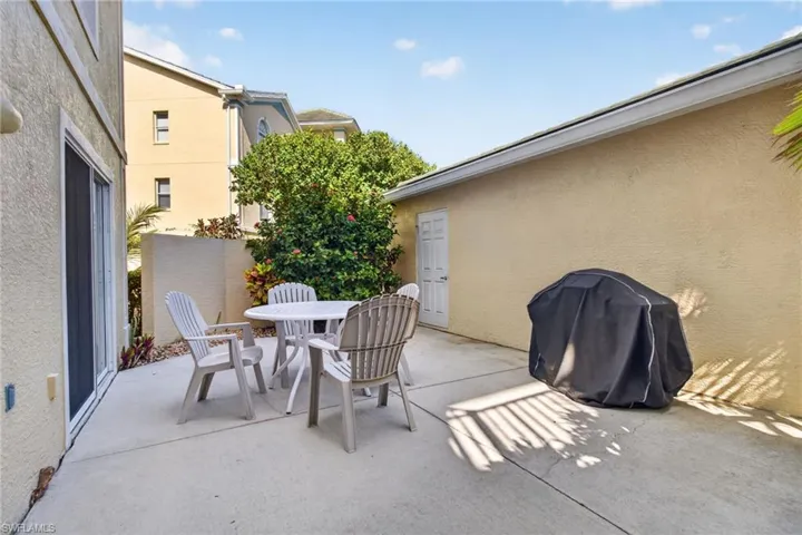This view of the patio from the kitchen door shows the direct entrance into the unit's garage.