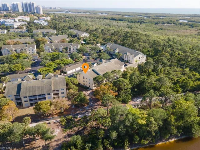 Aerial view of the property looking southwest, with the Bay Forest trail in the foreground, and the boardwalk and Gulf in the background.