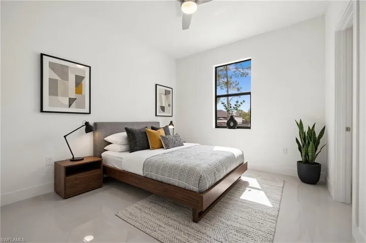 Bedroom featuring a ceiling fan and baseboards