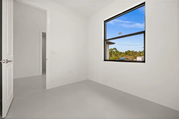 Unfurnished room featuring baseboards and light tile patterned floors