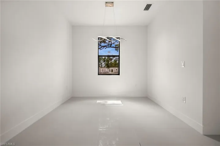 Unfurnished dining area featuring baseboards