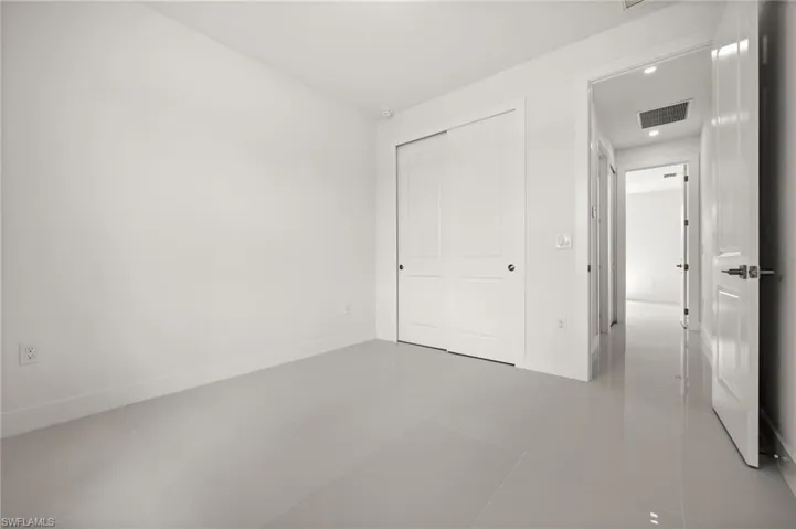 Unfurnished bedroom featuring a closet and light tile patterned floors