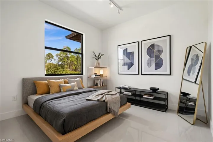 Bedroom with baseboards and rail lighting