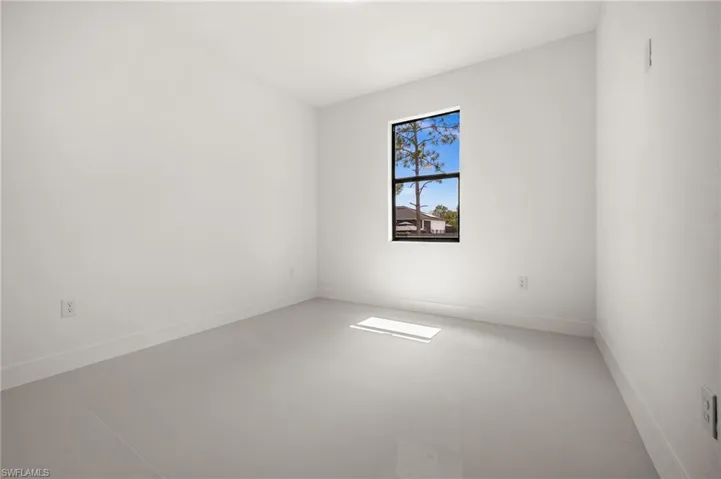 Empty room featuring baseboards