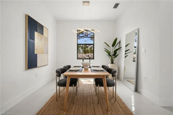 Dining space with suspended lighting and baseboards