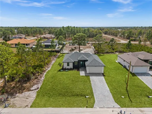 Aerial view of residential area featuring a tree filled landscape