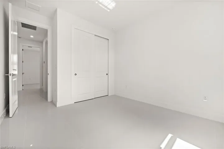 Unfurnished bedroom featuring a closet and light tile patterned floors