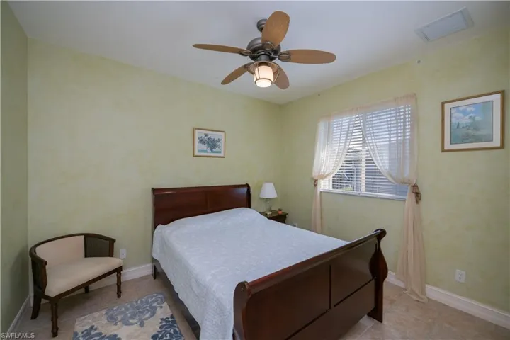 Bedroom with tile patterned flooring and a ceiling fan