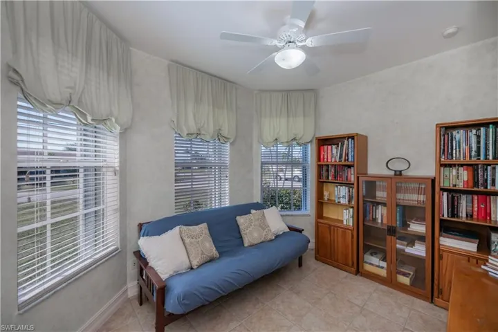 Sitting room featuring light tile patterned floors and ceiling fan