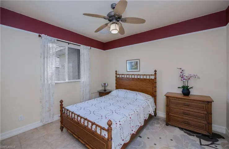 Bedroom featuring a ceiling fan and tile patterned floors
