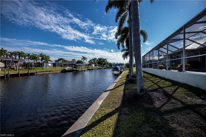Water view with a dock and nearby suburban area