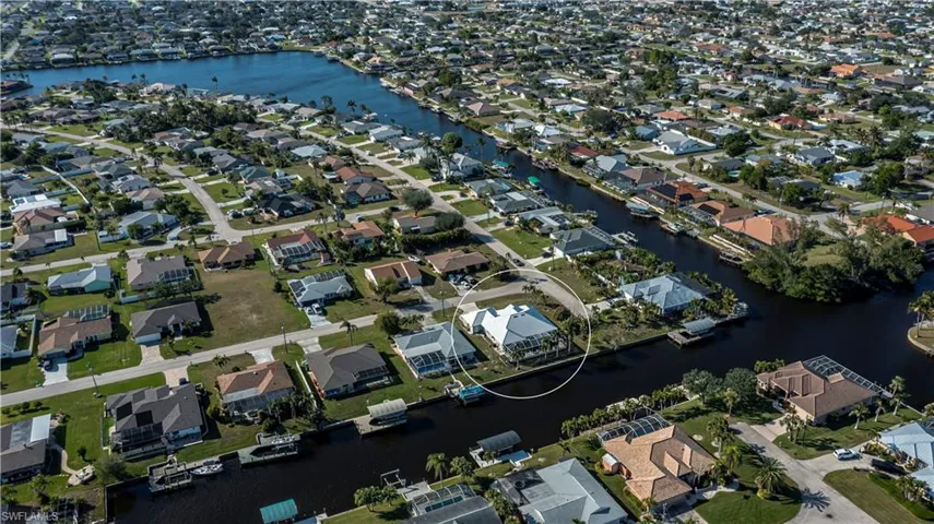 View of property location with a nearby body of water and nearby suburban area