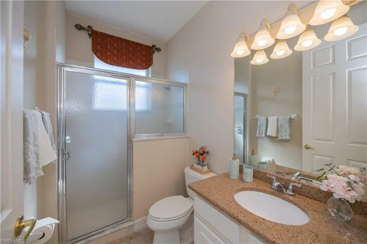 Bathroom featuring vanity, a stall shower, and tile patterned floors