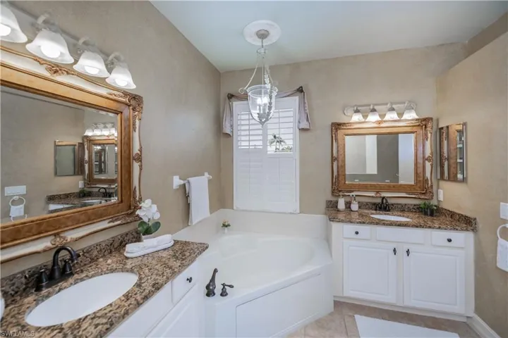 Full bath featuring a bath, tile patterned flooring, and two vanities