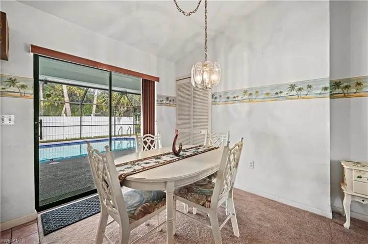 Dining room featuring carpet floors and a notable chandelier
