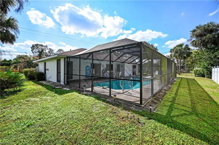 View of pool with a yard, a lanai, and a patio area