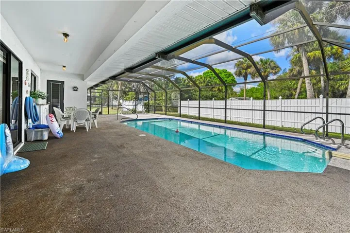 View of swimming pool featuring a lanai and a patio