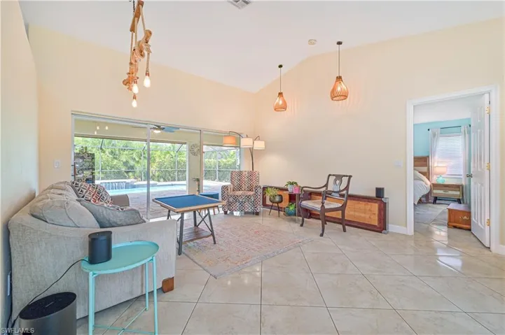 Tiled living room with high vaulted ceiling