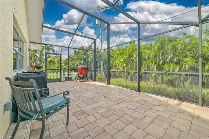 View of patio featuring glass enclosure