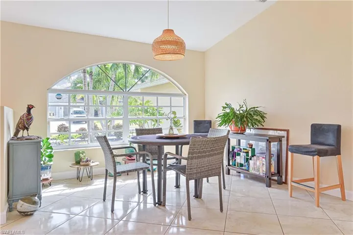 Dining area featuring lofted ceiling and light tile patterned floors
