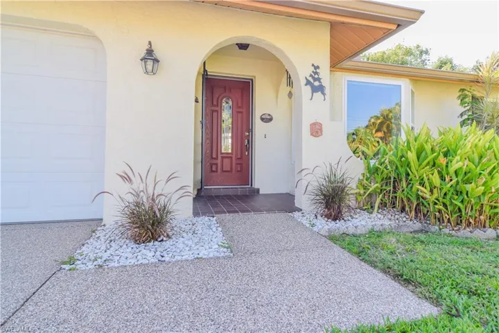 Doorway to property featuring a garage