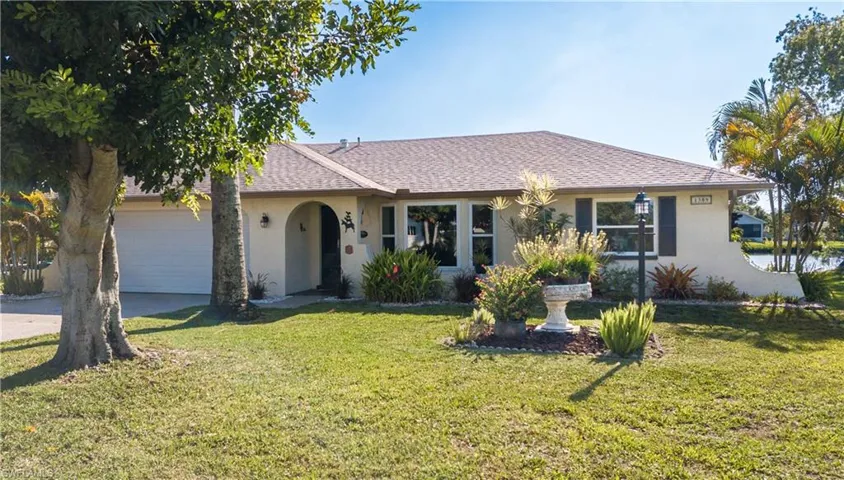 Ranch-style home with a 2 car garage and mature Landscaping.
