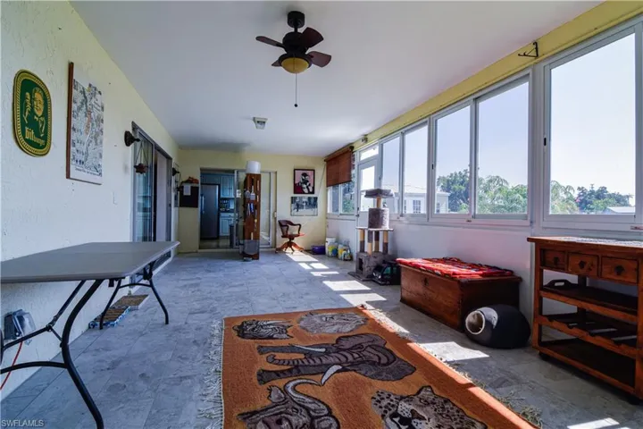 Sunroom / solarium featuring ceiling fan