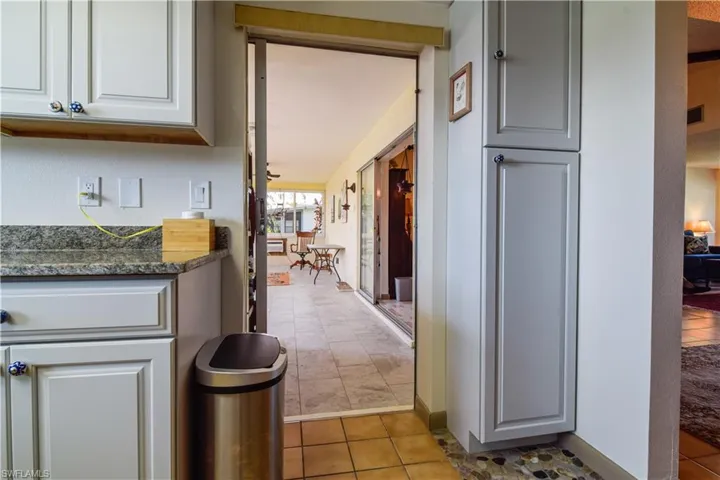 Kitchen with dark stone counters and light tile floors