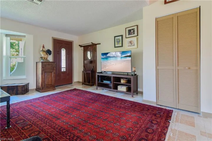 Tiled living room with a textured ceiling