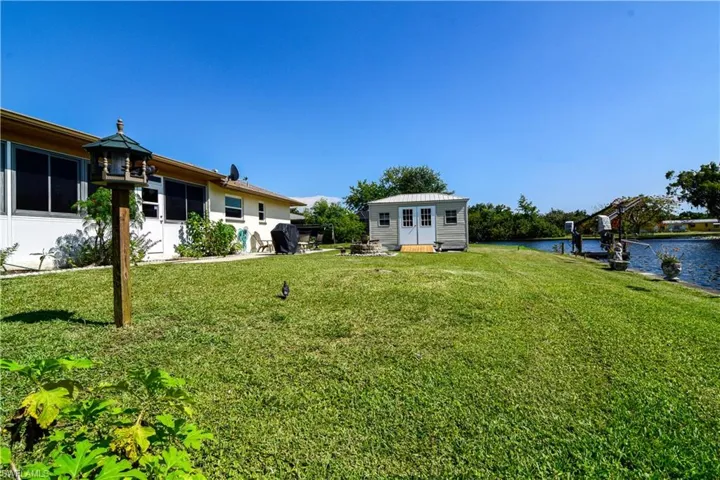View of yard with a water view and an outdoor structure