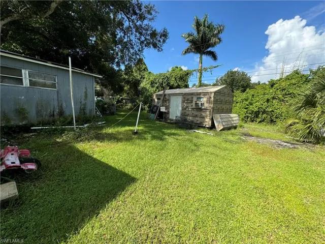 View of backyard with a shed