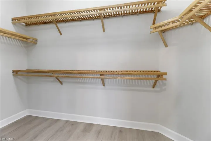 Spacious closet with light wood-type flooring