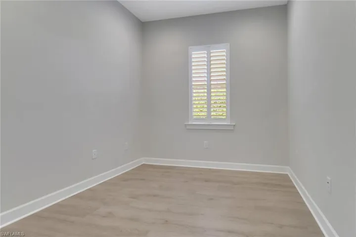 Empty room with light wood-type flooring and baseboards