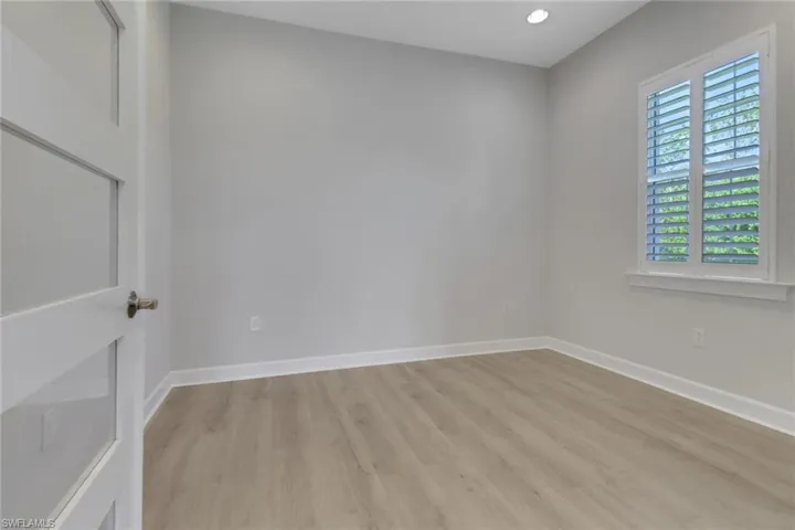 Empty room featuring baseboards and light wood-style floors
