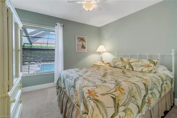 Carpeted bedroom with ceiling fan