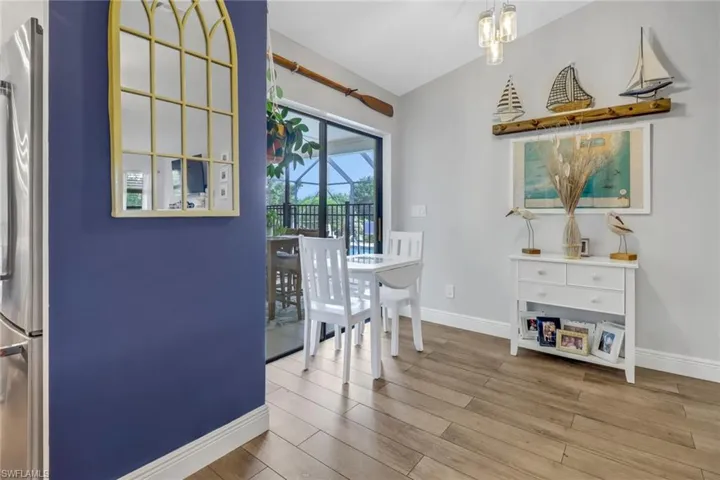 Breakfast noon featuring light hardwood / wood-style flooring and an inviting chandelier