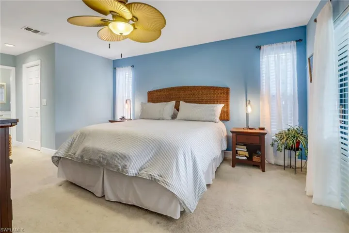 Bedroom featuring light colored carpet and ceiling fan
