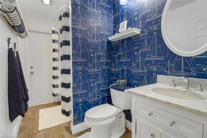 Bathroom with vanity, toilet, and hardwood / wood-style flooring