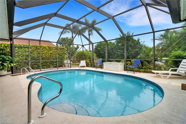 View of pool with a lanai and a patio