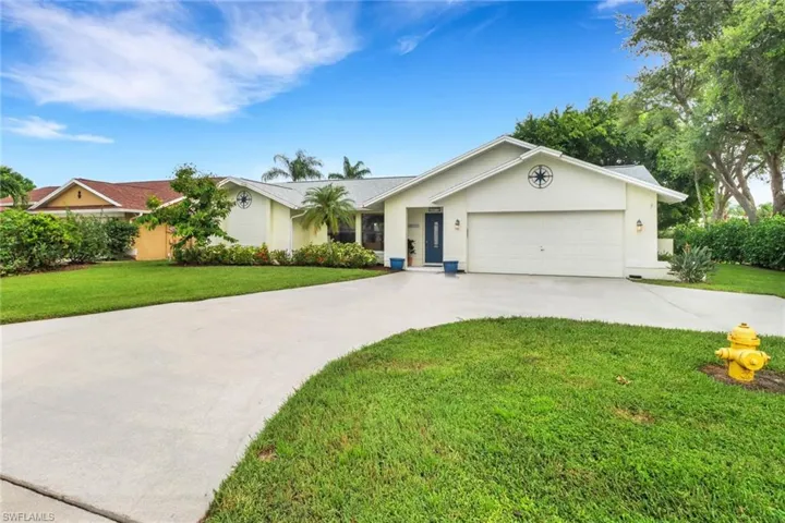 Ranch-style home with a front yard and a garage