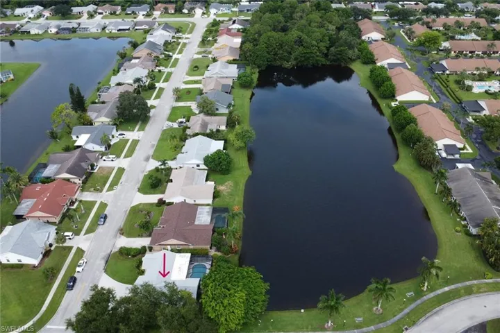 Birds eye view of property with a water view