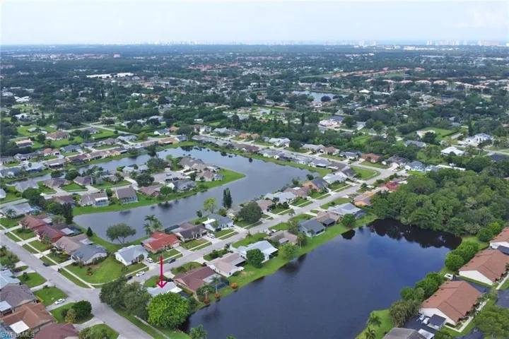 Birds eye view of property with a water view