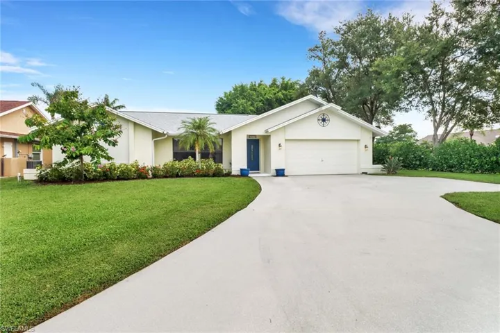 Ranch-style home featuring a garage and a front yard