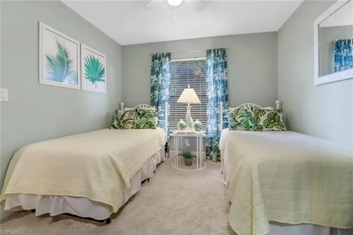 Bedroom featuring ceiling fan and light colored carpet