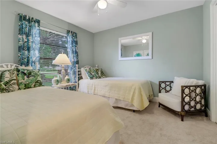 Carpeted bedroom with ceiling fan