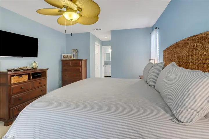 Bedroom with ceiling fan and ensuite bathroom